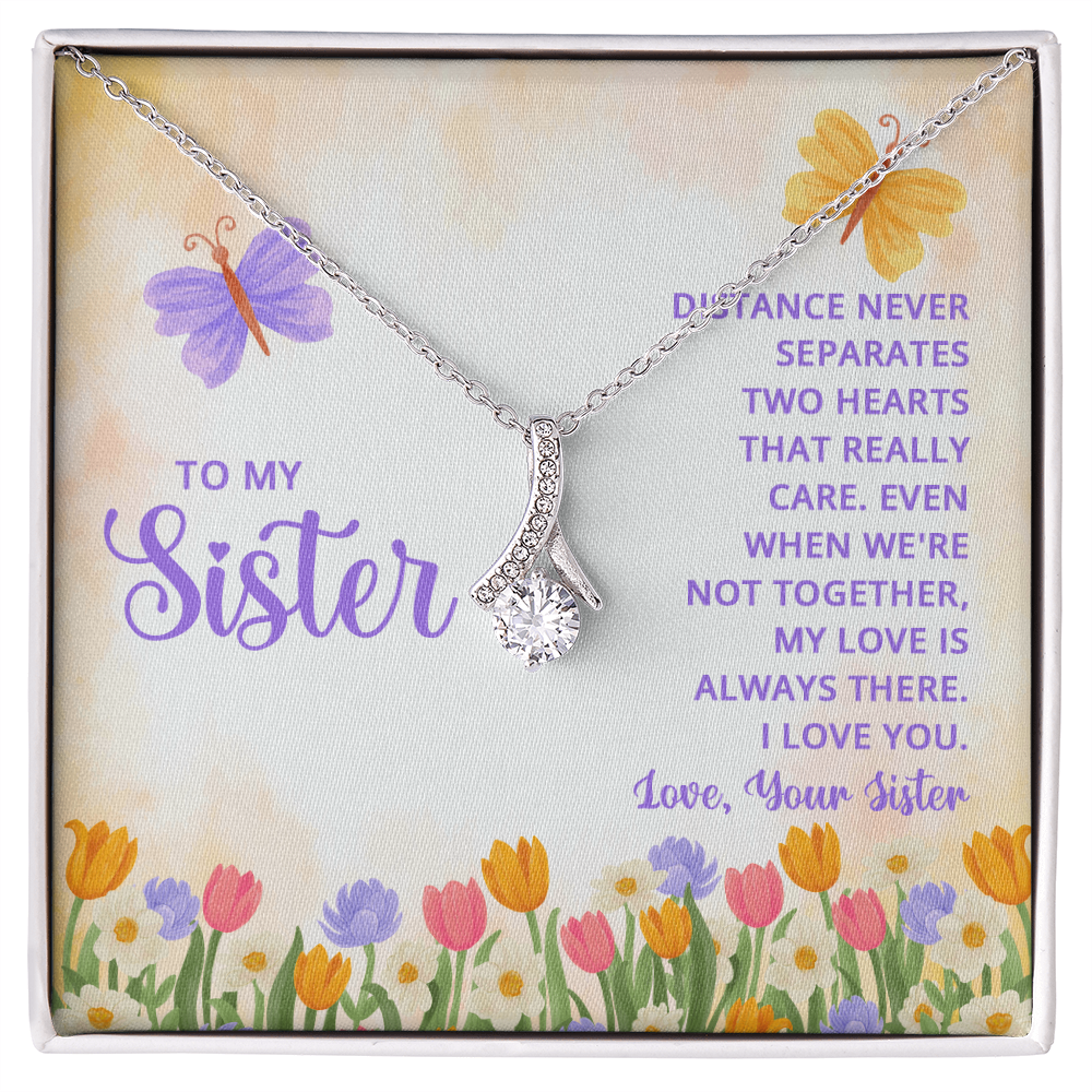 Alluring Beauty necklace for a sister with a message card that reads "Distance never separates two hearts that really care" and a floral butterfly design