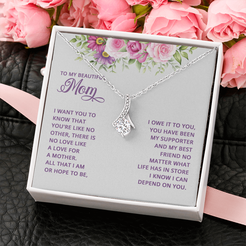 Alluring Beauty necklace for Mom with a message card that reads "All that I am or hope to be, I owe it to you" inside a gift box
