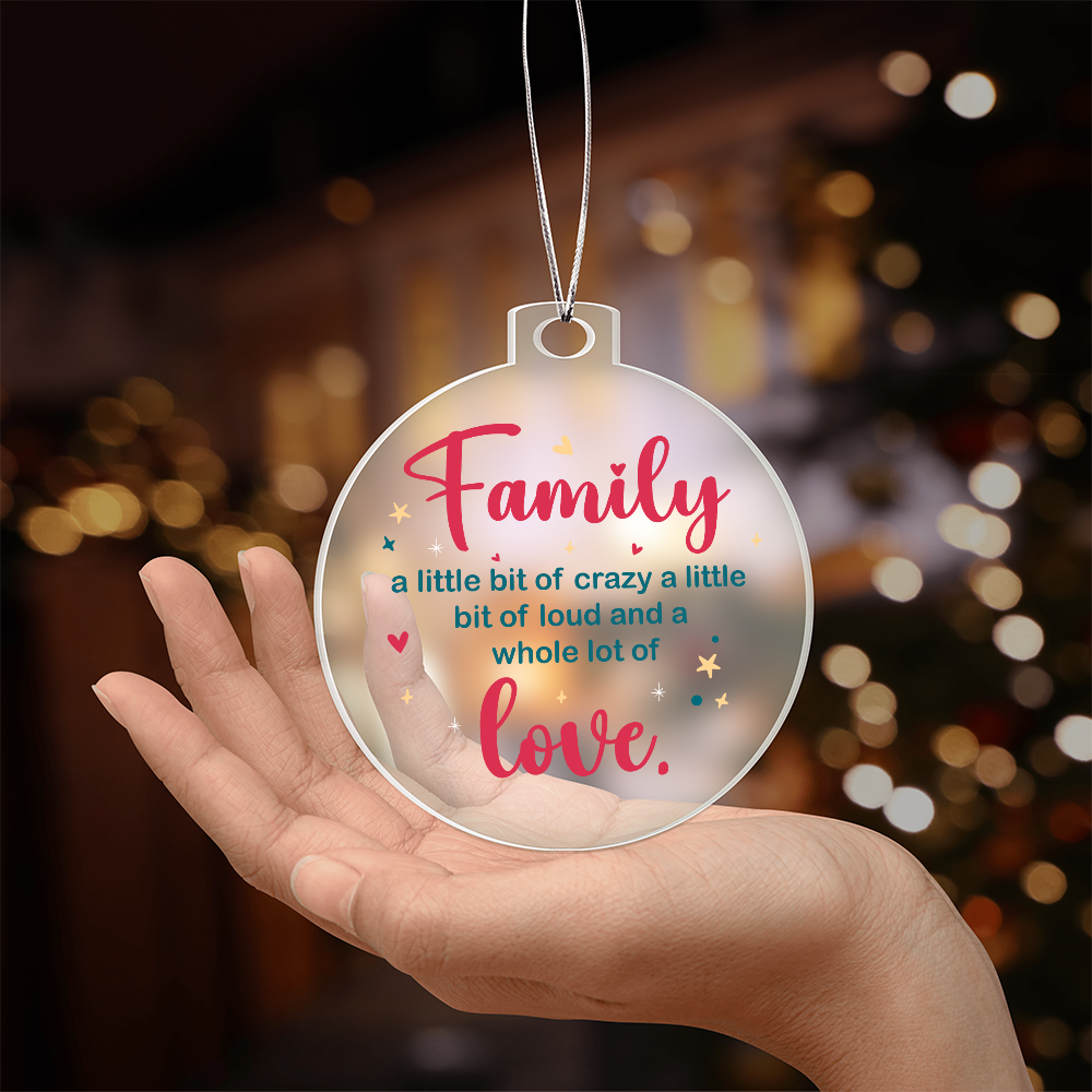 Clear acrylic family ornament with the quote 'a whole lot of love' sitting inside a gift box.